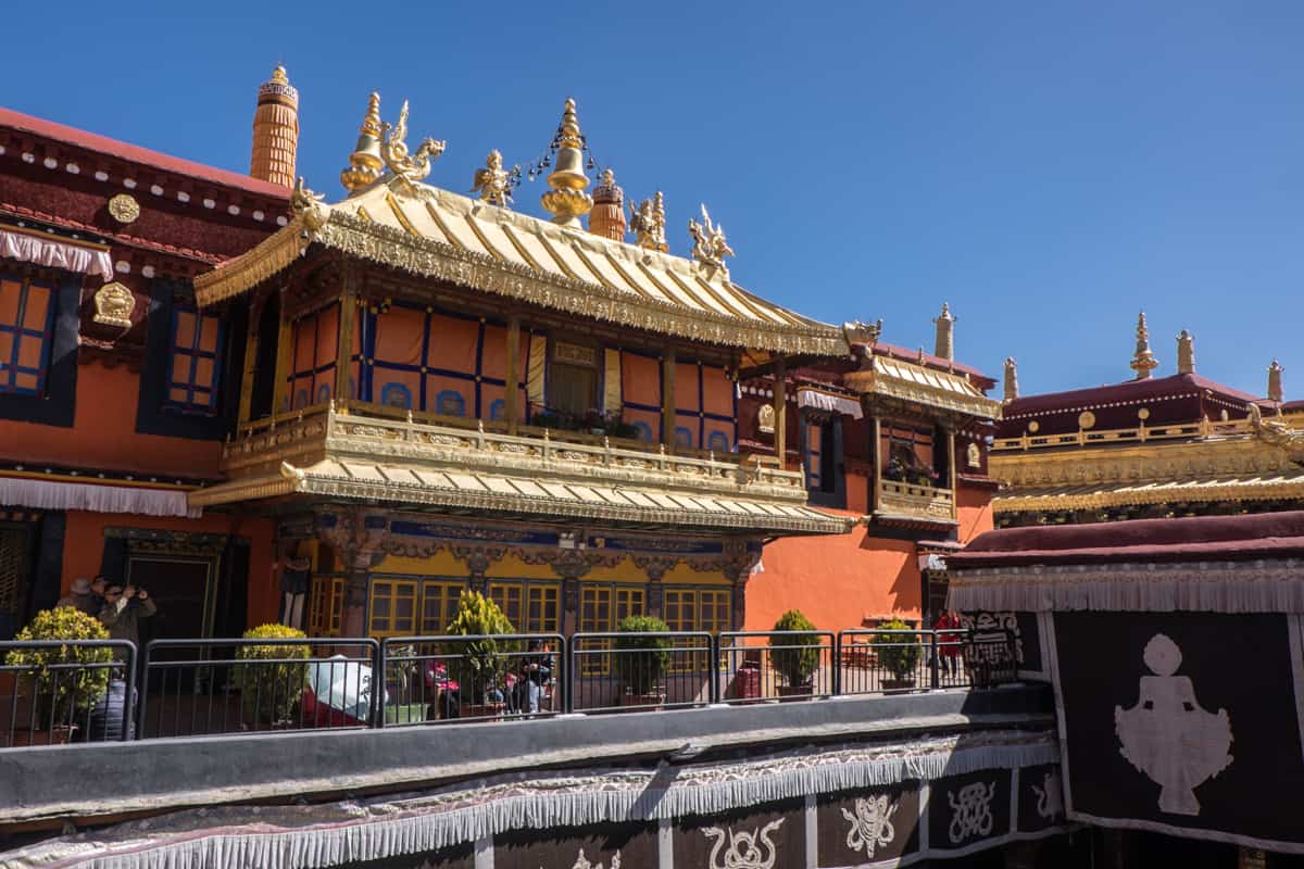 The two-tiered golden roof and balcony found inside the Jokhang Temple in Lhasa Tibet where tourists can visit on a tour
