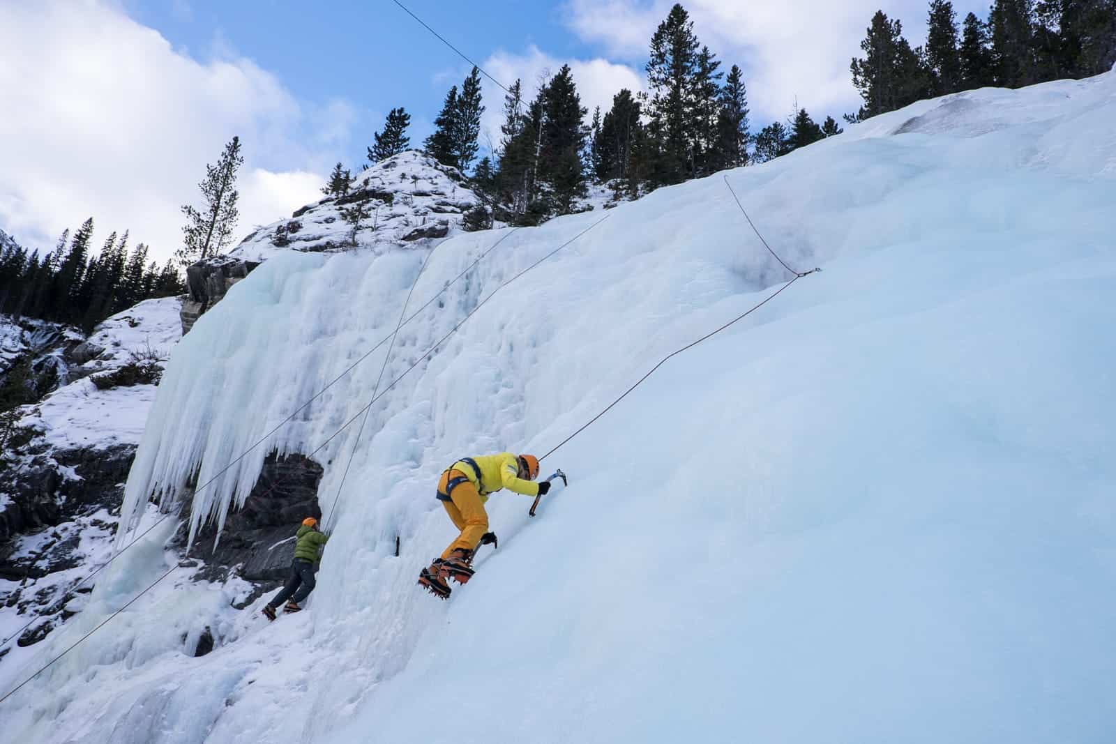 Tourist learns how to ice climb in Banff in winter 