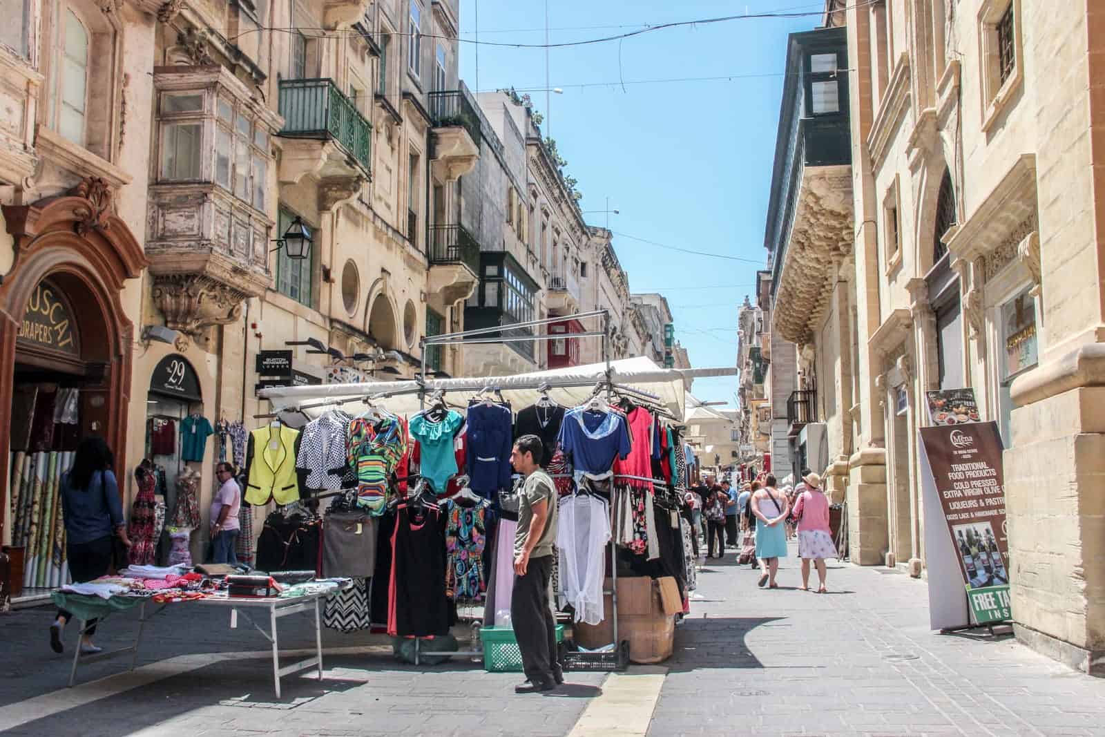 Man selling goods at a market stall in Valletta in Malta