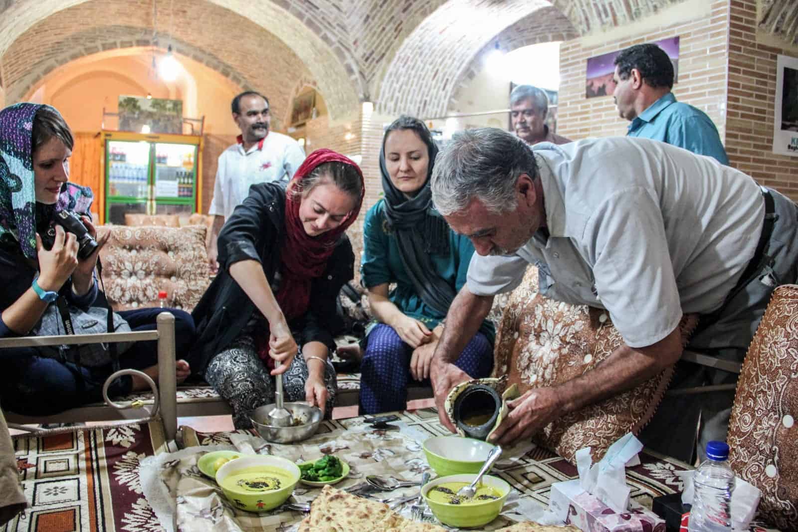 Tourists trying Persian food in Iran