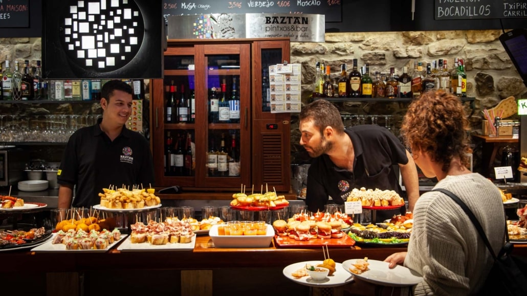 Helping yourself to Pintxos on a bar in San Helping yourself to Pintxos on a bar in San Sebatsian