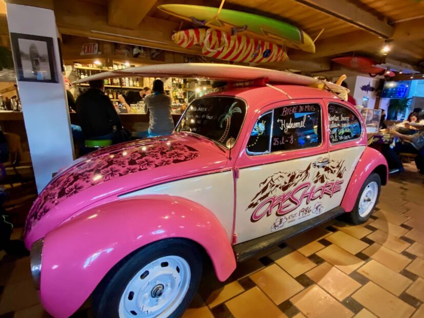 pink beetle car inside off shore restaurant in verbier