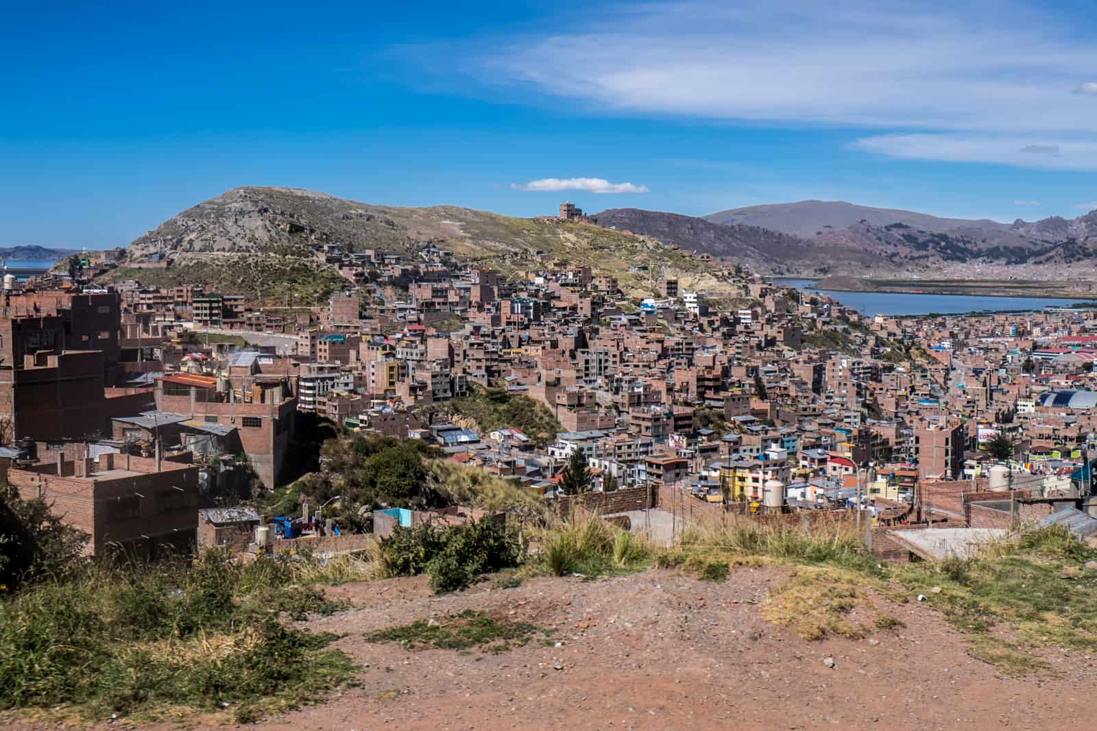 Elevated view over the compact town of Puno next to Lake Titicaca in Peru.