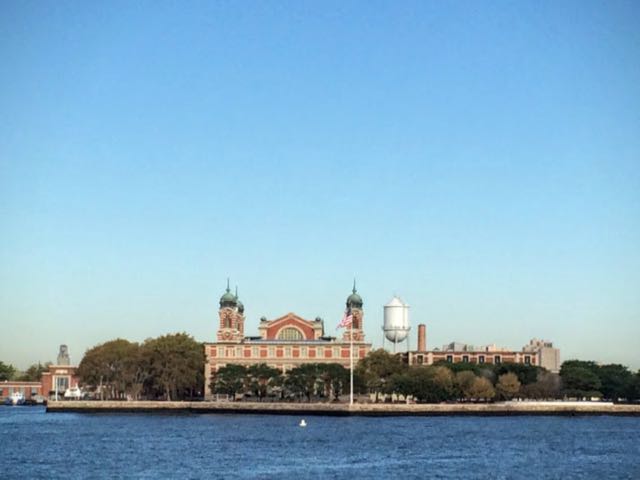 view of Ellis island in New york approaching by ferry