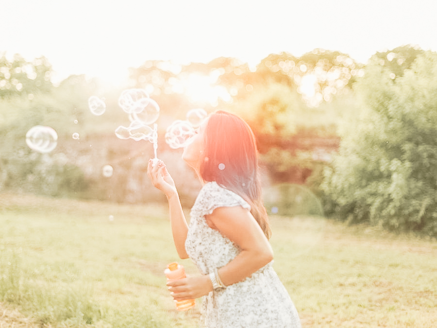 A woman blowing bubbles