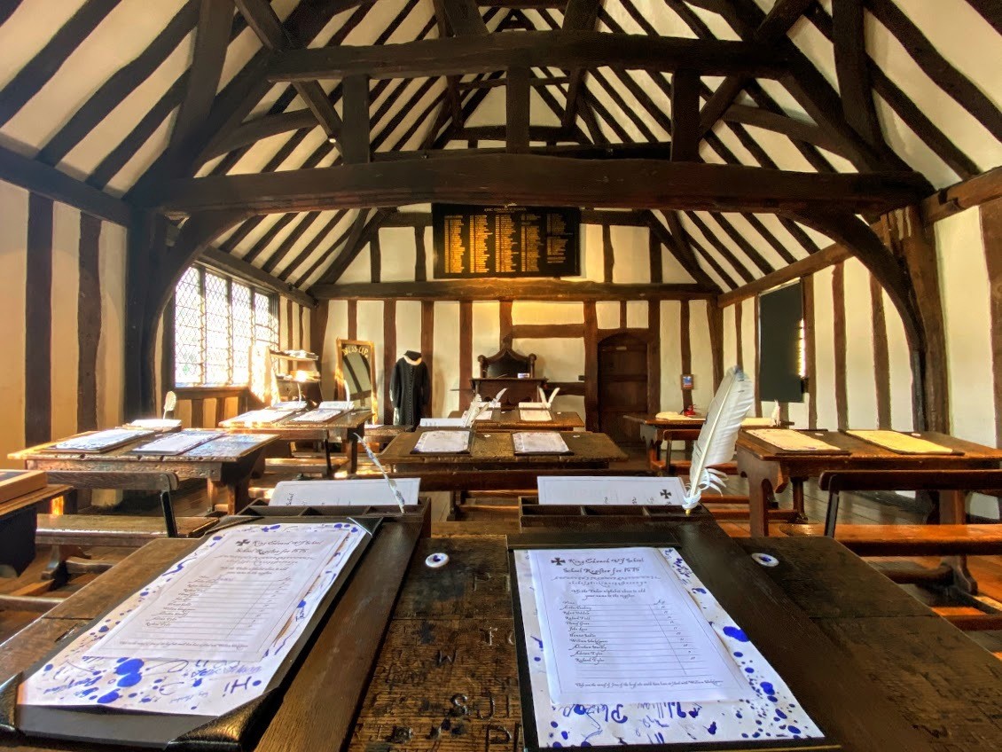 Inside Shakespeare's classroom with desks and paper and quill