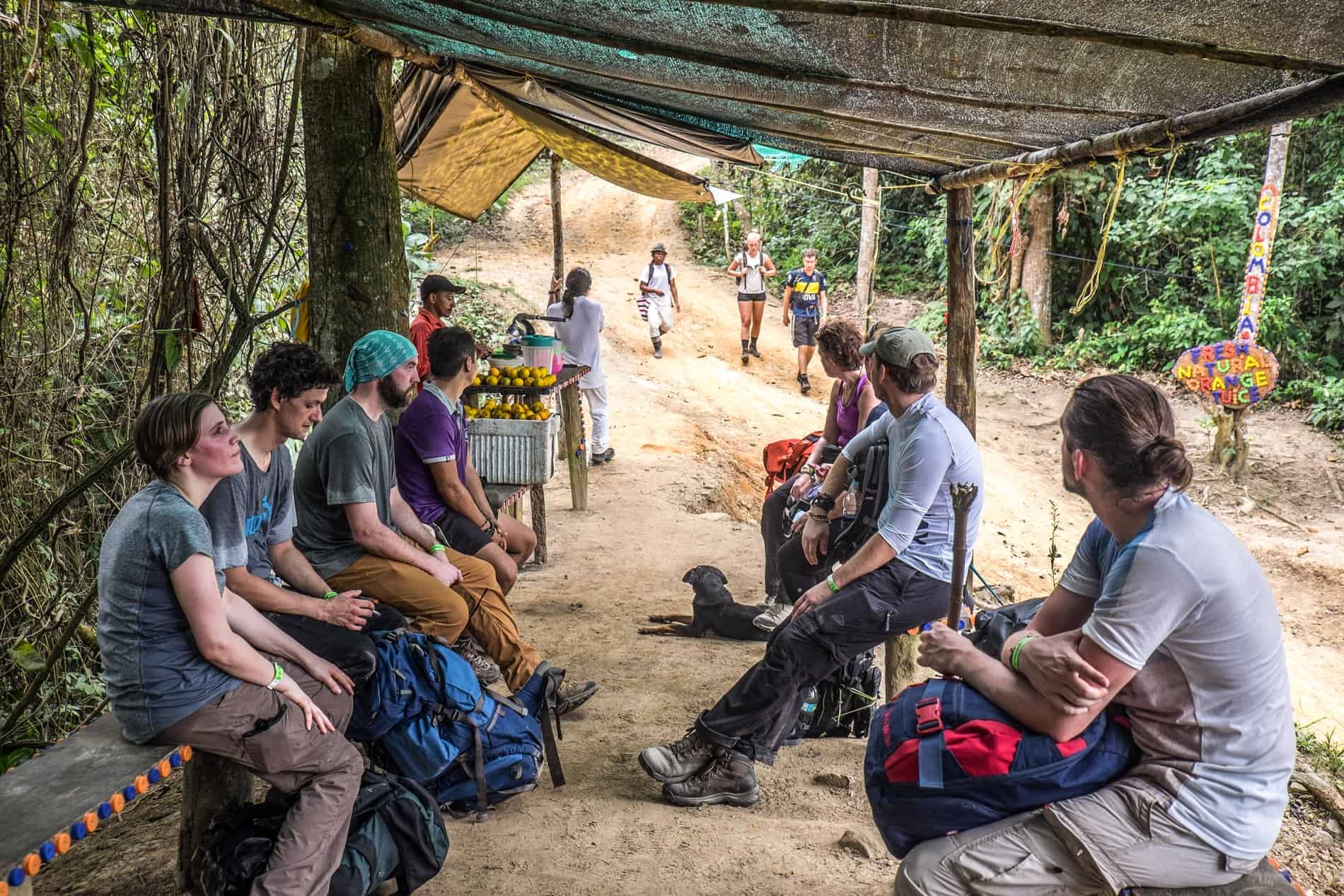 A trekking group rests at a local orange juice stand on the Lost City hike, Colombia.