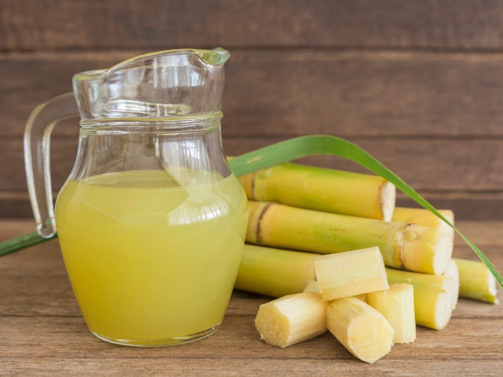 jug of sugar cane juice with chopped cane