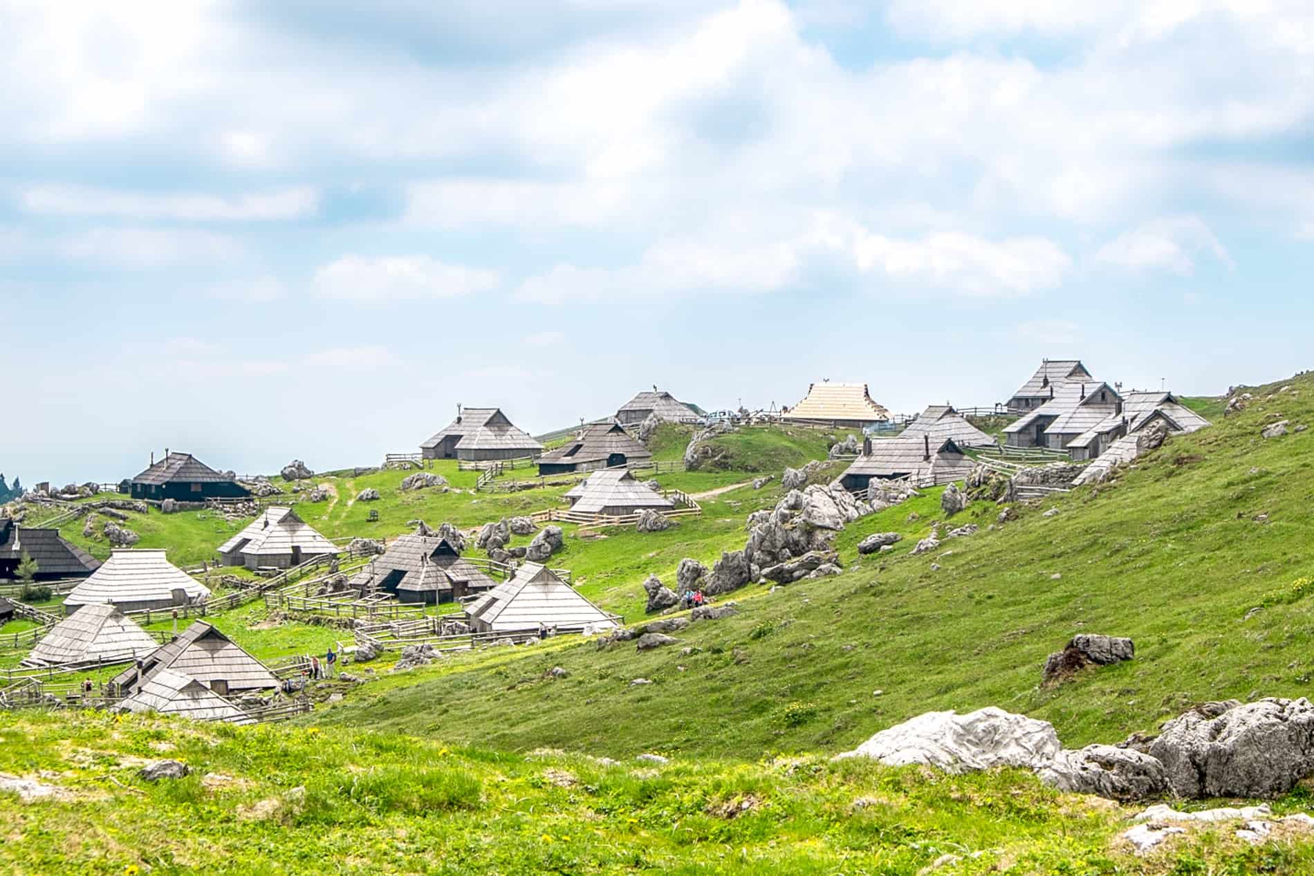 A Golden Roof amongst the distinct silvery houses in the Velika Planina mountaintop Shepherd Settlement in Slovenia. 