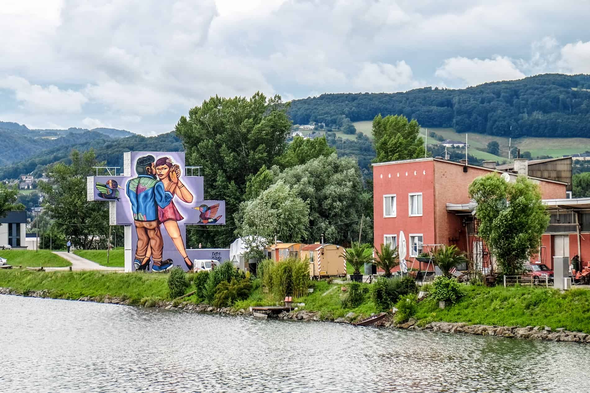 The Danube riverside Linz Harbour art mural wall showing a couple dancing. 