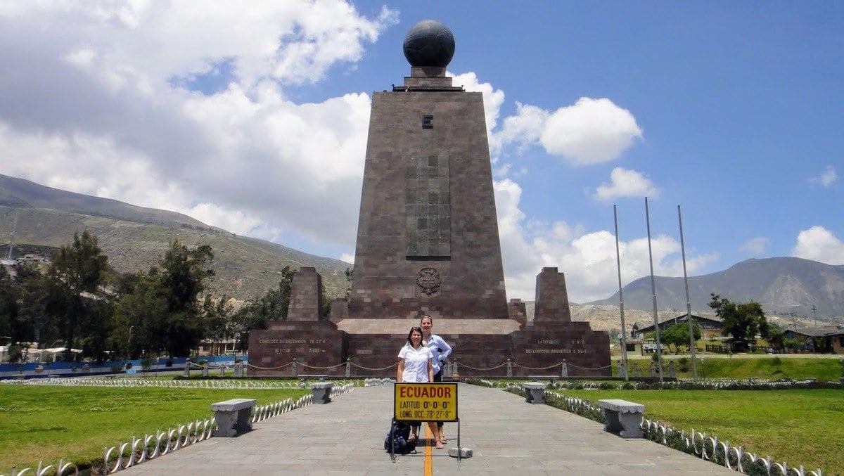 standing across the equator line in quito
