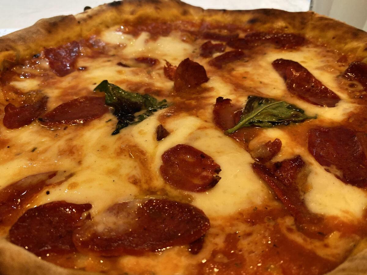 Meat pizza with cheese and basil
