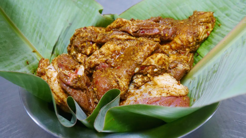 Omani lamb shuwa being prepared in a banana leaf