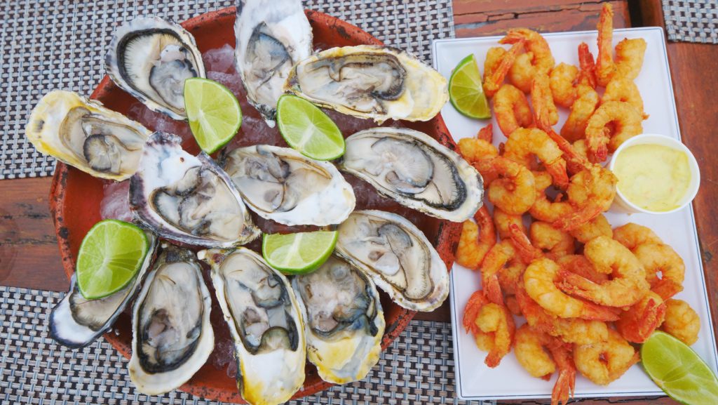 Brazilian seafood (raw oysters and fried shrimp) in Florianopolis, Brazil