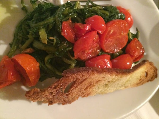 Wilted greens and tomatoes with bread