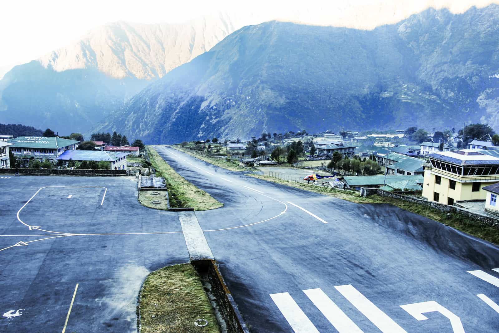 The famously short mountain-side runway at Lukla airport in Nepal, which is super close to the Himalaya mountain range that surrounds it