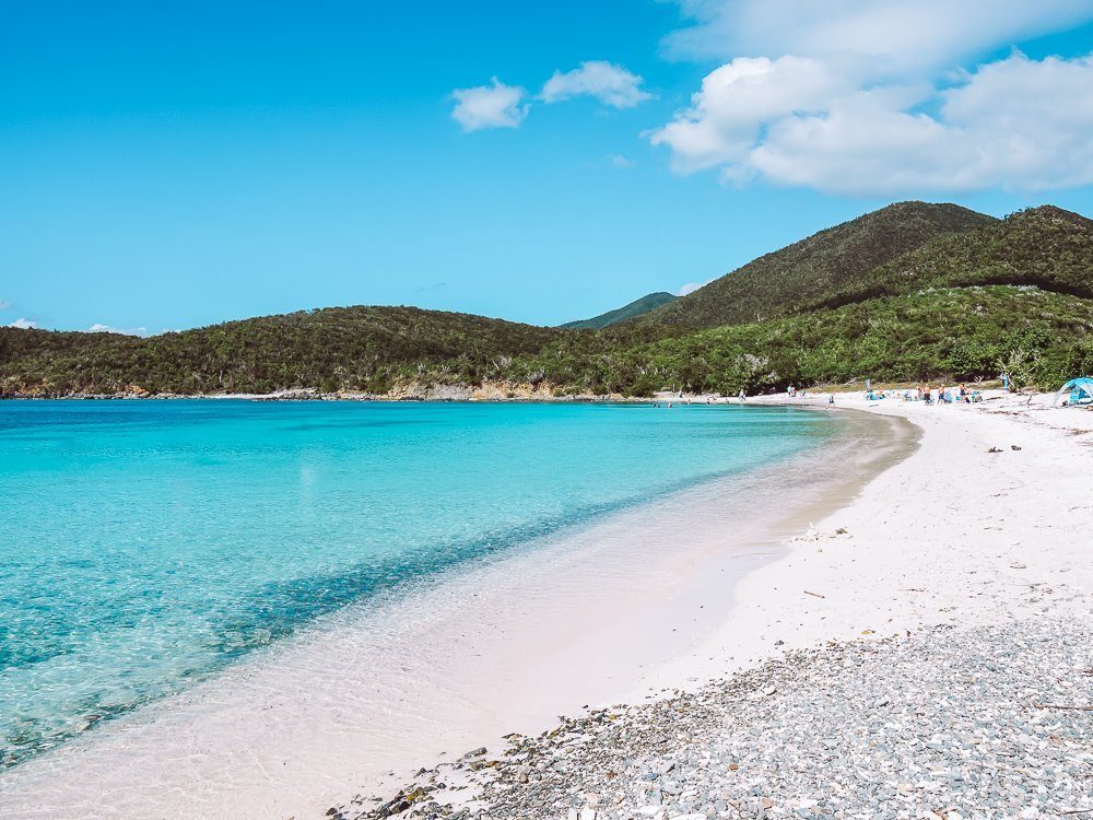 fluffy white sand and bright blue water of salt pond bay beach in virgin islands national park