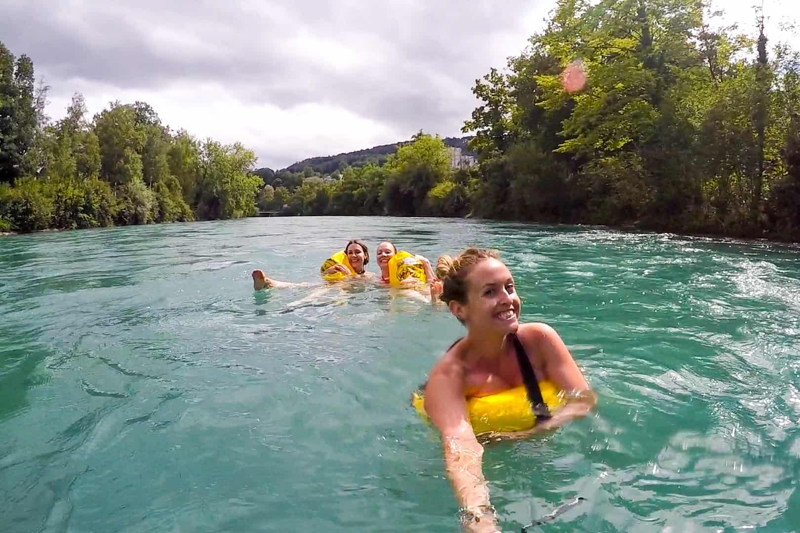 Three women swimming in the Aare River in Bern, Switzerland, as locals do