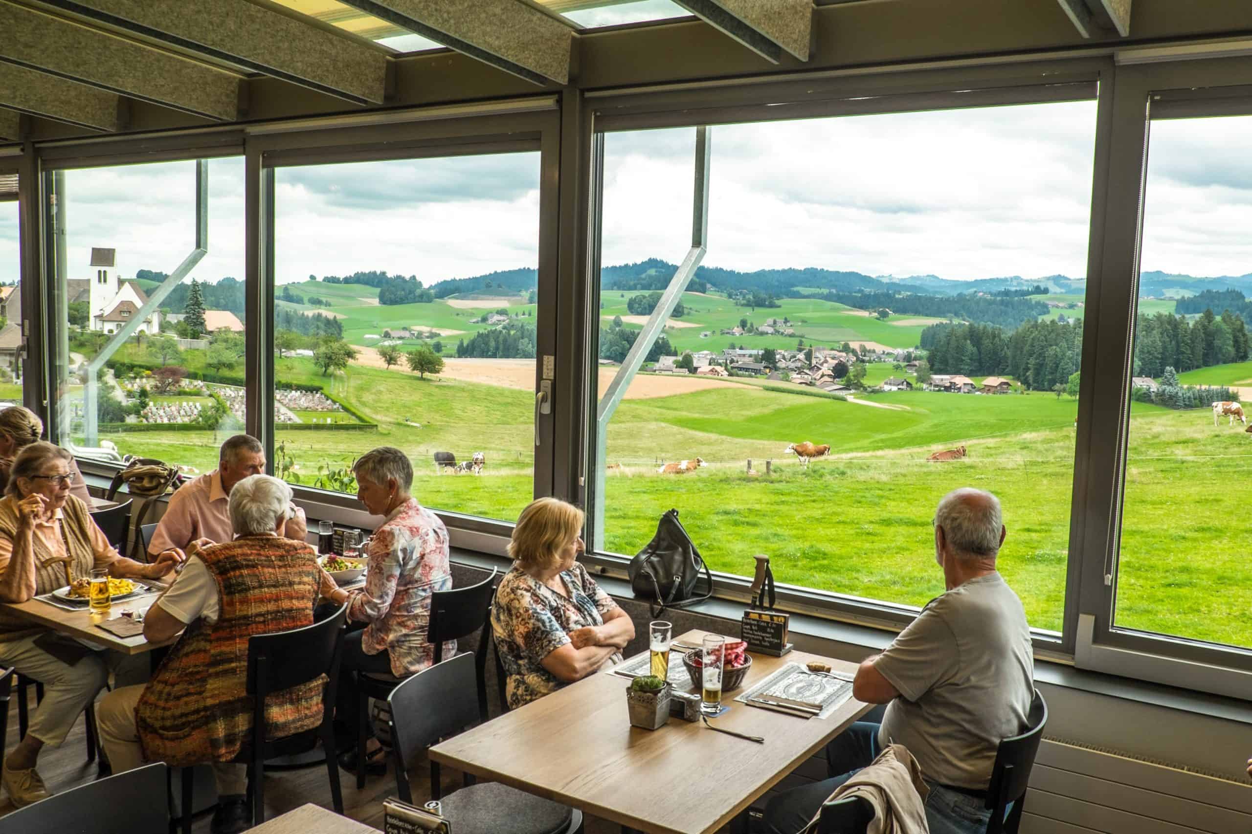 A group of people enjoyung Lunch at Emmentaler Showdairy in Emmental Valley, Switzerland