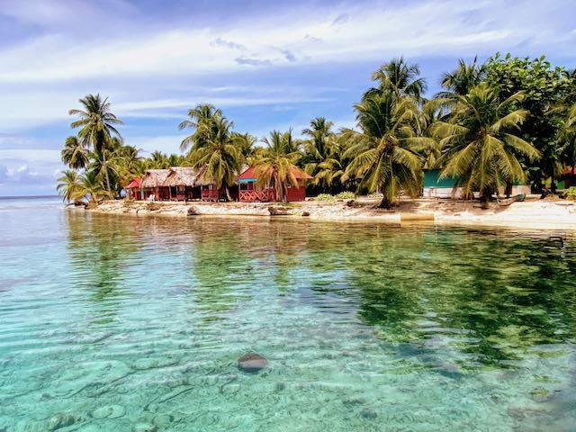 island with palm trees and huts san blas islands in panama