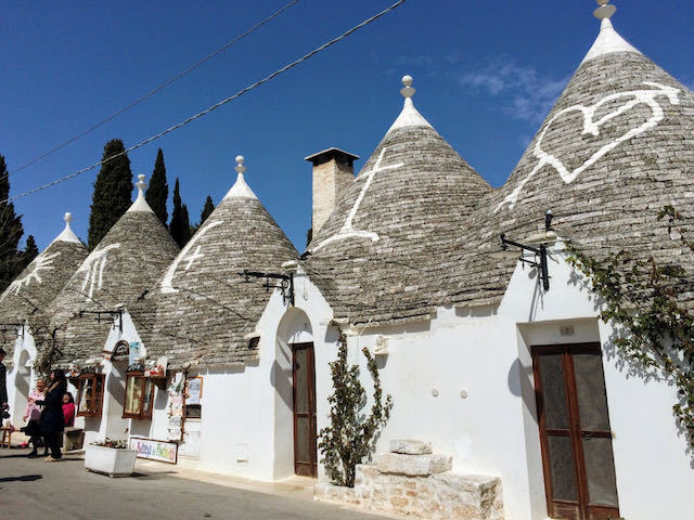 round white trulli houses with thatched roofs in Alberobello puglia italy