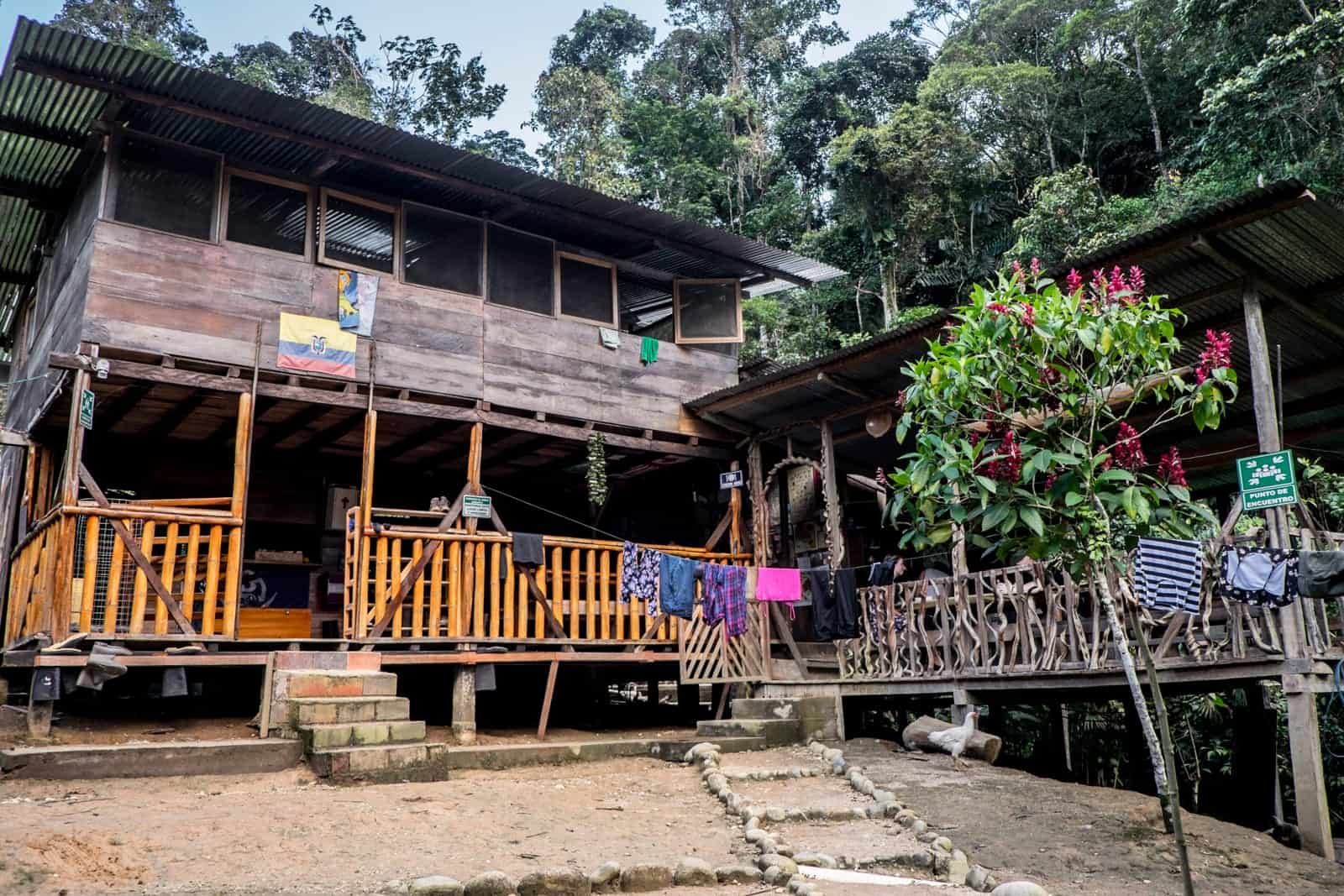 A two story wooden house and a single story wooden hut - a local house in the Ecuador Amazon Rainforest.
