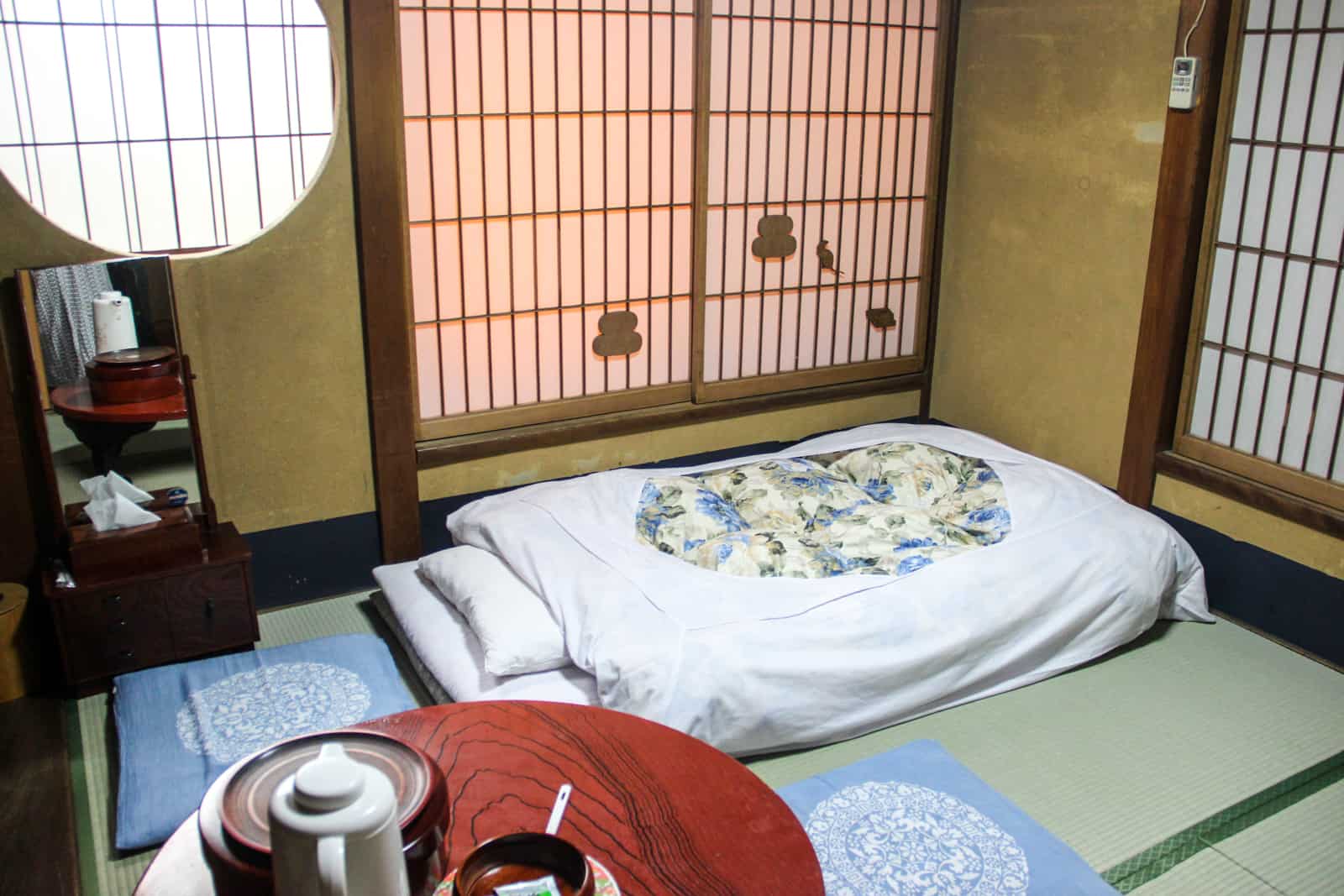 Traditional Japanese accommodation with shuttered windows, a floor bed and tea table - known as a Ryoken.