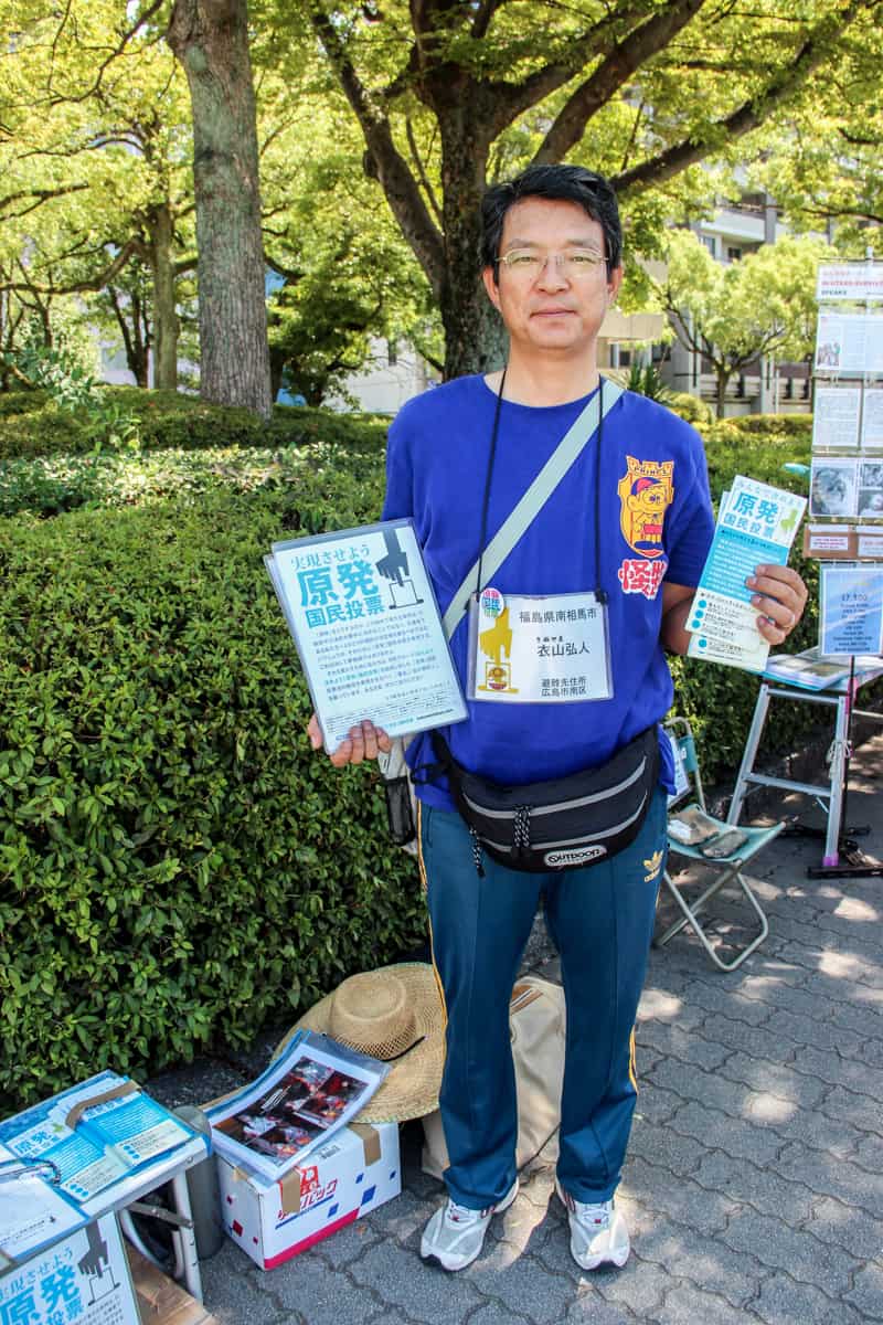 A peace activist in Hiroshima holding information leaflets. 
