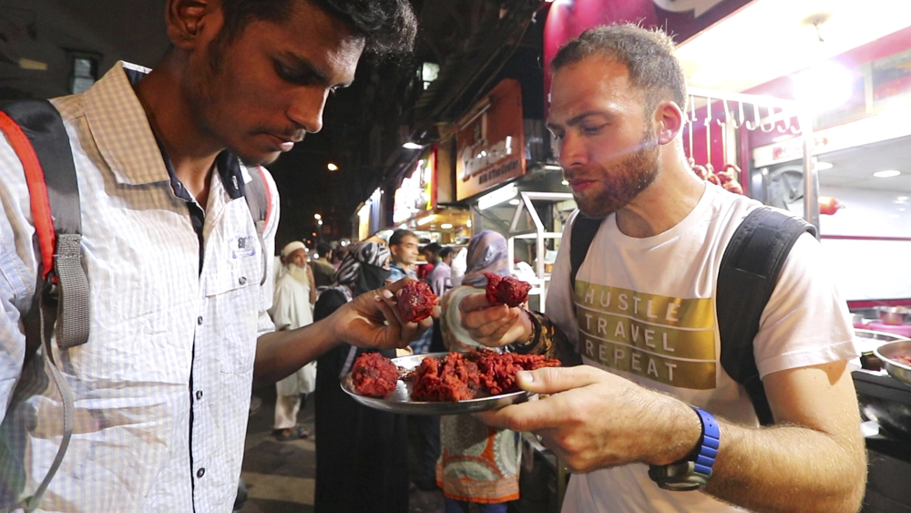 David Hoffmann and a friend enjoying chicken lollipops in Mumbai