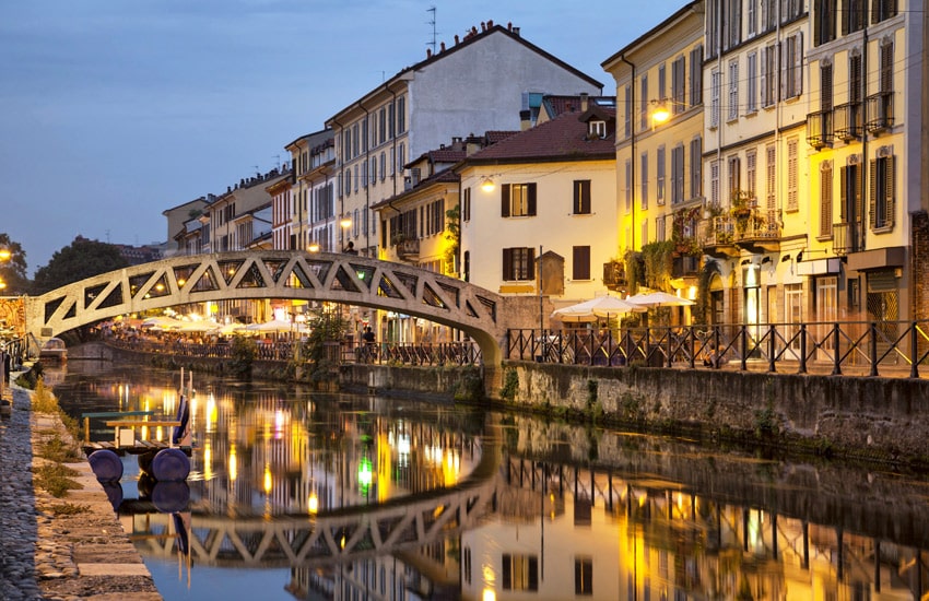 ITALY-ROAD-TRIP-MILAN-Bridge-across-the-Naviglio-Grande-canal-at-the-evening-in-Milan-Italy
