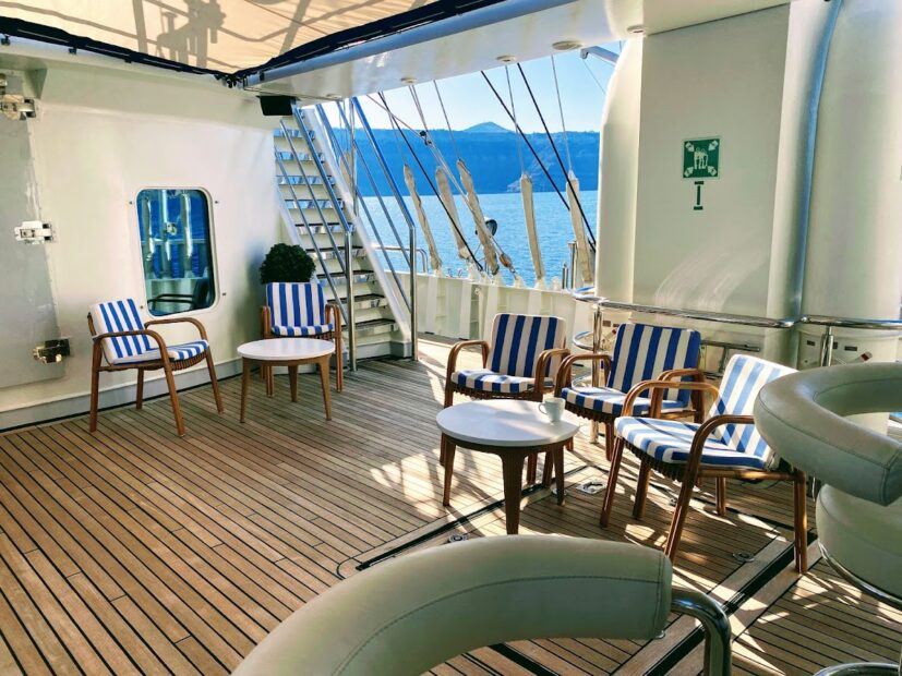 The Ocean Bar on the Running on Waves Cruise with attractive blue striped seats and wooden deck