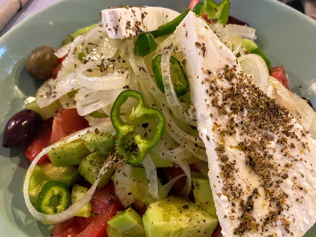 Greek salad with cucumber, tomato, onion and triangles of feta cheese with oregano