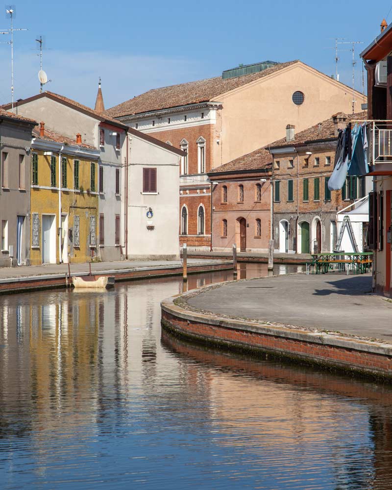 Canals reflects colourful houses in Comacchio