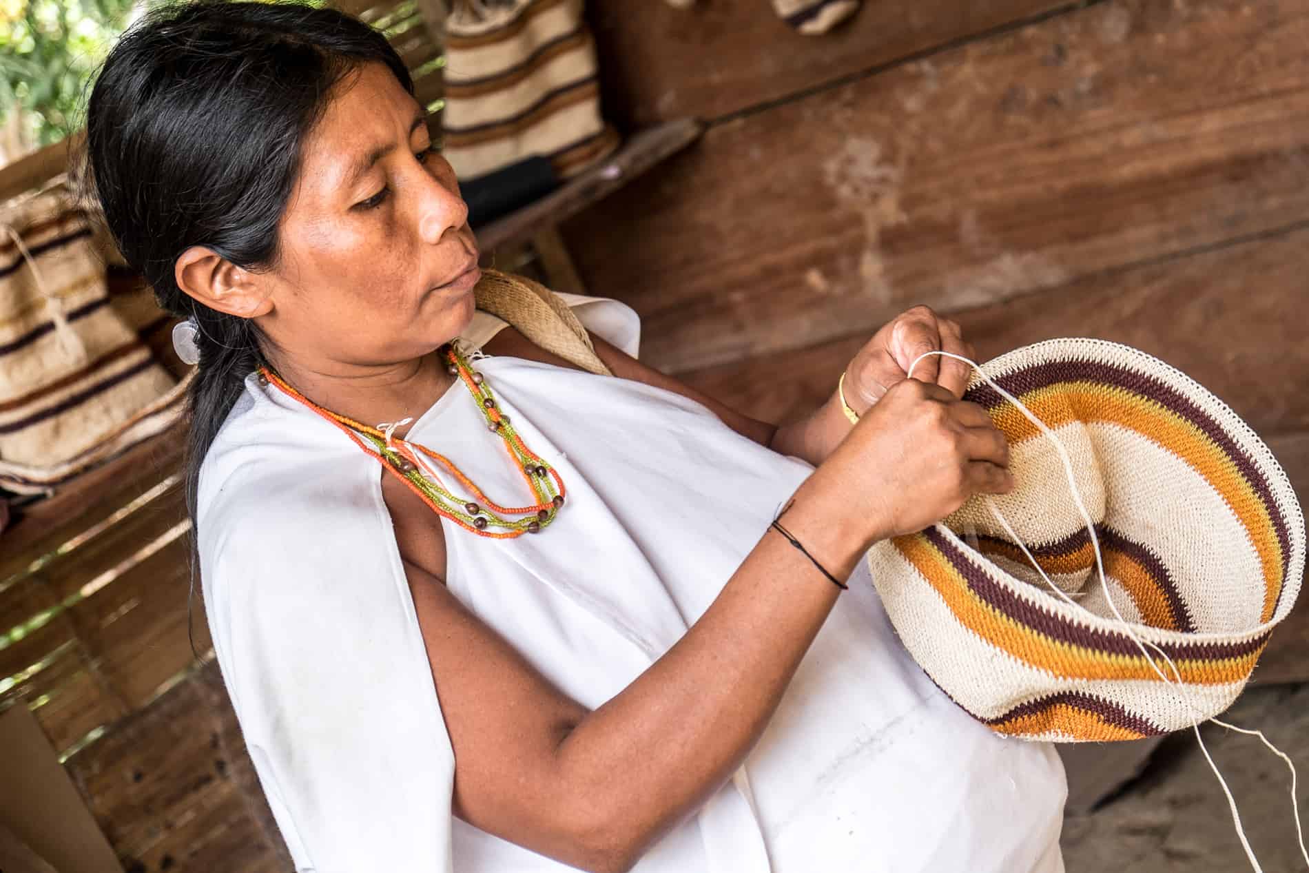 A Wiwa woman weaving a basket at Wiwa Village in Sierra Nevada Colombia