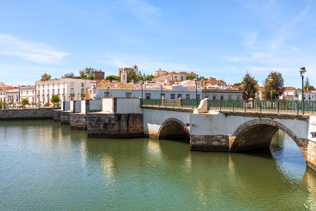 The Ponte Antiga de Tavira bridge crosses the River