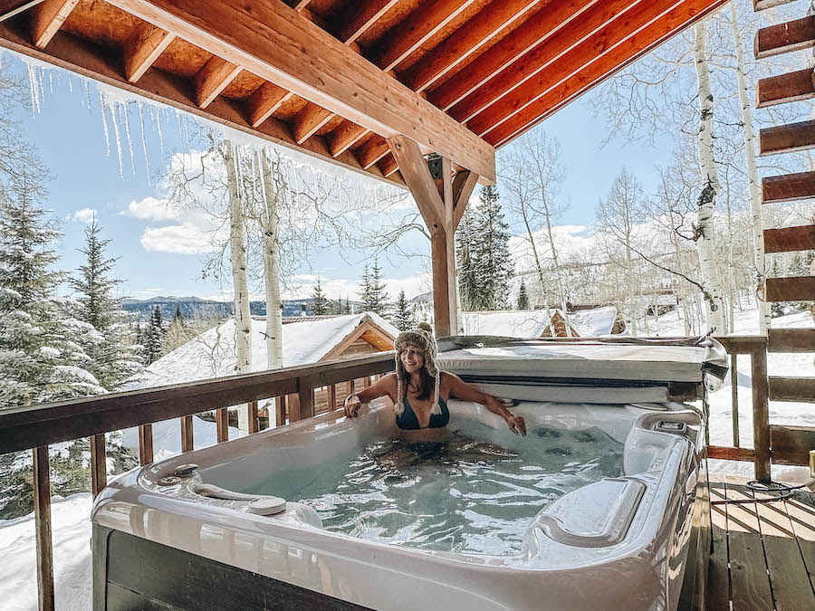 Annette enjoying her hot tub outside her cabin on Vista Verde Guest Ranch Colorado